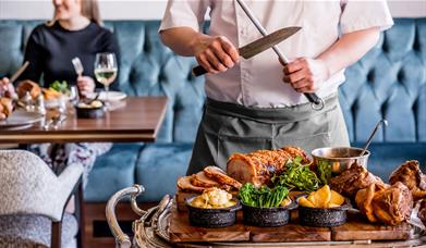 Chef Carving in the Restaurant at The Borrowdale Hotel in Borrowdale, Lake District