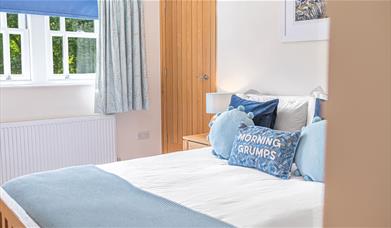 Double Bedroom with Decorative Pillow that reads "Morning Grumps" at Springbank Cottage in Coniston, Lake District