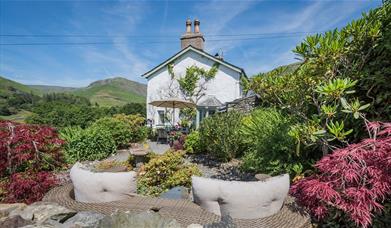 Outdoor seating and garden at Broadrayne Farm Cottages in Grasmere, Lake District