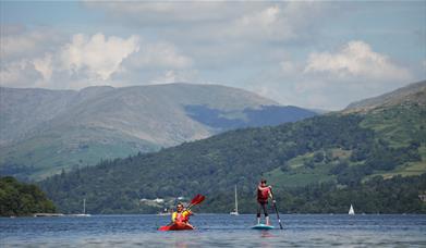 Visitors Kayaking and Paddleboarding at Windermere Canoe Kayak in the Lake District, Cumbria