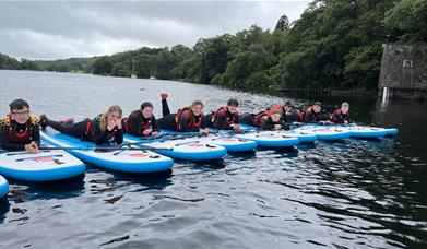 Visitors Paddleboarding with Genuine Adventures in the Lake District, Cumbria