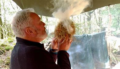 Visitor Starting a Fire on the Intensive 72 hour Survival Experience with Green Man Survival