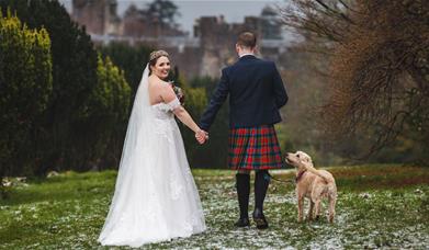 Bride and Groom Posing with Scenery at Muncaster Castle in Ravenglass, Lake District