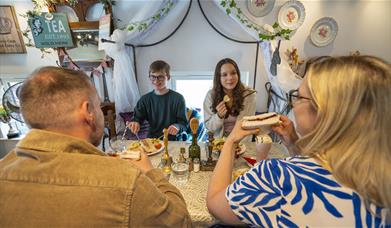 Family enjoying food and drink at The Fairydust Emporium in Silloth, Cumbria