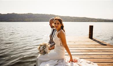 Bridal Couple posing for portraits at a Wedding at The Ro Hotel in Bowness-on-Windermere, Lake District