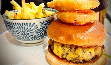 Burger with chips and onion rings from The Last Zebra in Carlisle, Cumbria