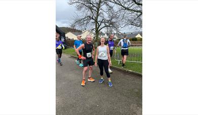 two runners smiling after completing a race