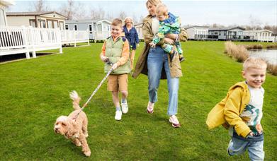 Family with dog at Lakeland Leisure Park in Flookburgh, Cumbria