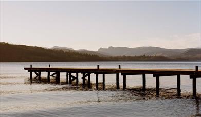 A photo by Juliet Klottrup of a wooden jetty outstretched over a lake in Cumbria