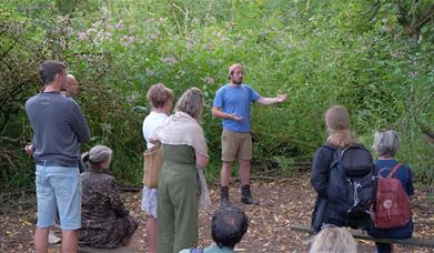 A man holding a Foraging workshop outdoors