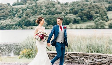 Bridal couple walking on the grounds of Daffodil Hotel & Spa in the Lake District, Cumbria