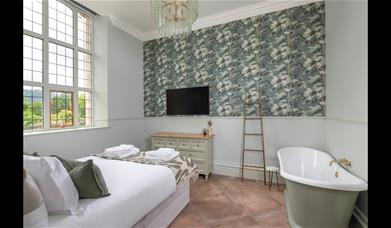 Main bedroom with bathtub at The Fernery at The Lingholm Estate in Portinscale, Lake District