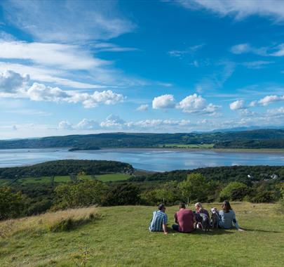 Friends sat by Arnside Knott looking over the river Kent