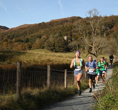 People running through the lake district