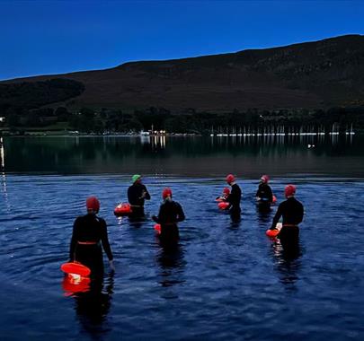 Visitors Enjoying the Stargazing Night Swim at Another Place, The Lake in Ullswater, Lake District