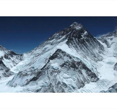 Snow-covered mountain range with deep blue sky