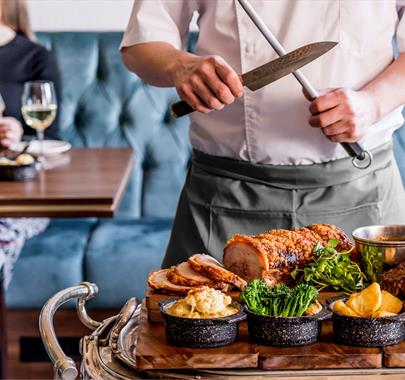 Chef Carving in the Restaurant at The Borrowdale Hotel in Borrowdale, Lake District