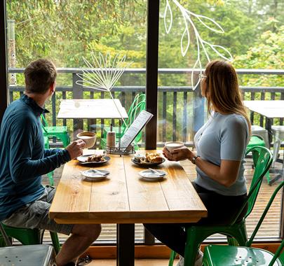 Couple enjoying lunch at at Cafe Ambio in Whinlatter Forest in the Lake District, Cumbria