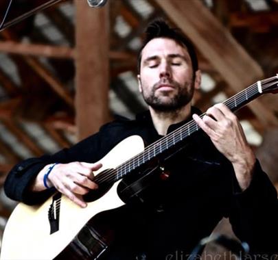 Simon Kempston playing guitar live