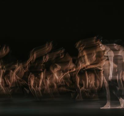 Long exposure photo of a women in a black dress