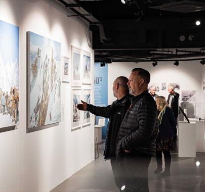 Visitors viewing artwork at the Everest Revisited Exhibition at Rheged in Penrith, Cumbria