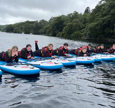 Visitors Paddleboarding with Genuine Adventures in the Lake District, Cumbria