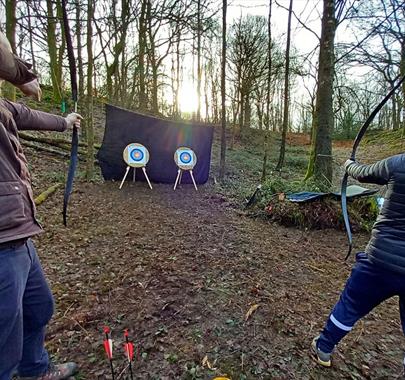 Visitors Shooting at Archery Targets with Green Man Survival in Newby Bridge, Lake District