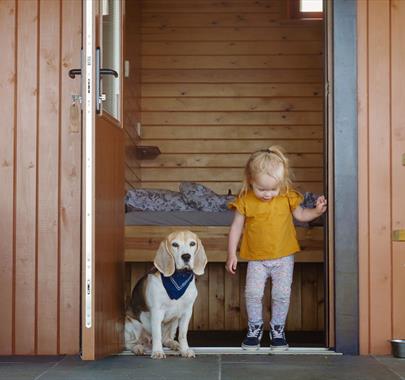 Child and Dog at Glamping Burrows at The Quiet Site Holiday Park in Ullswater, Lake District