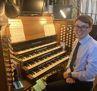 Picture of Harry Brown sitting by a organ