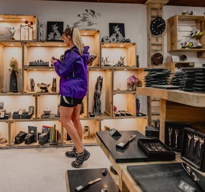 Visitor browsing shop at at Honister Slate Mine in Borrowdale, Lake District