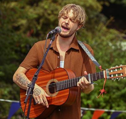 Performer singing at an event held by BarrowFull in Barrow-in-Furness, Cumbria