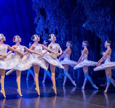 A still from the ballet "Swan Lake". showing a group of 9 ballerinas