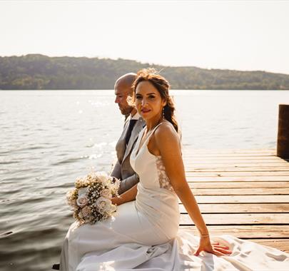 Bridal Couple posing for portraits at a Wedding at The Ro Hotel in Bowness-on-Windermere, Lake District