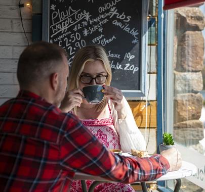 Visitors having coffee at The Wharf Ice Cream and Coffee House in Maryport, Cumbria