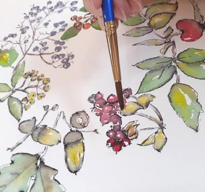 someone painting a botanical illustration with watercolors.