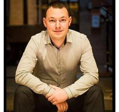 A photo of Edward Taylor sitting down