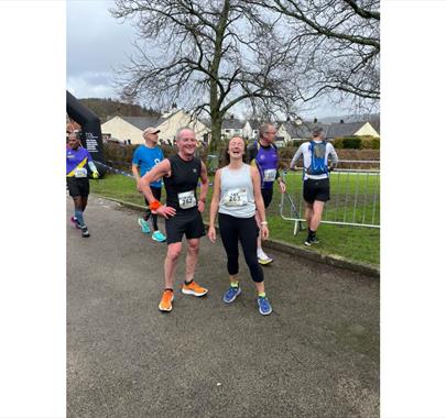 two runners smiling after completing a race
