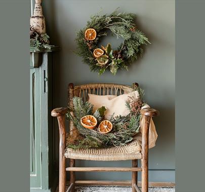 wicker seat with a Christmas wreath