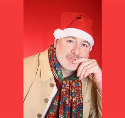 A close up of a man wearing a santa hat