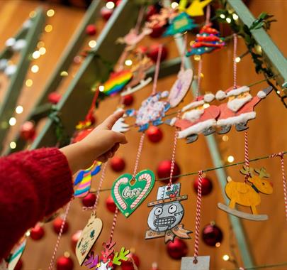 A child pointing at some Christmas decorations