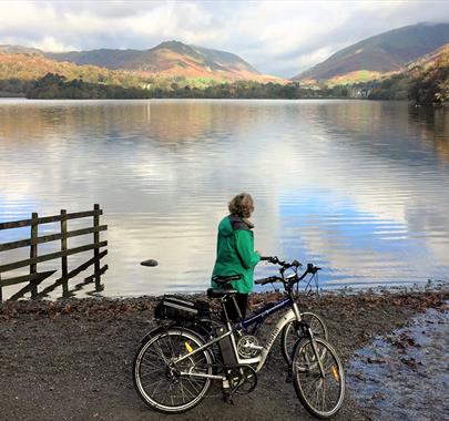 Cyclist Standing Lakeside on a Cycling Holiday in the Lake District, Cumbria from The Carter Company