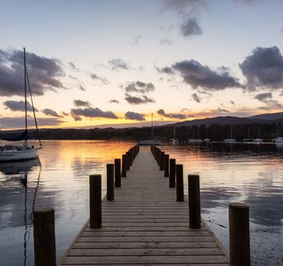 View from a Jetty over Windermere with a Dramatic Sunset in the Lake District, Cumbria