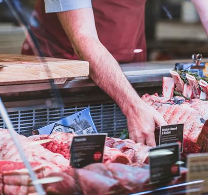 Chris Russell with beef at the butchers counter at Cranstons Orton Grange Food Hall near Carlisle, Cumbria
