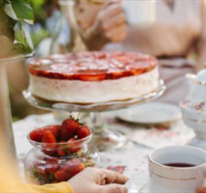 two people sat around an afternoon tea spread