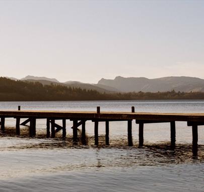 A photo by Juliet Klottrup of a wooden jetty outstretched over a lake in Cumbria