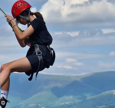 Visitor rock climbing with Newlands Adventure Centre in the Lake District, Cumbria