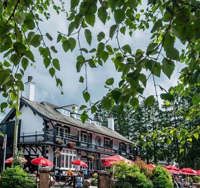 Exterior and lush plants in the summer at Pooley Bridge Inn in the Lake District, Cumbria