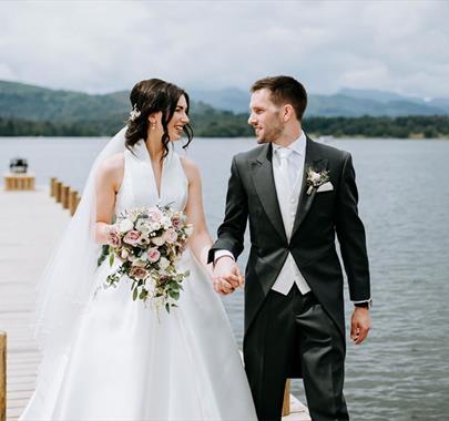 Bride and Groom on a Jetty at a Wedding at Low Wood Bay Resort & Spa in Windermere, Lake District
