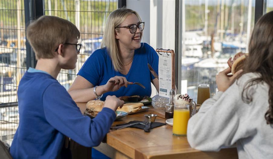 Family having food & drink at Marina View Cafe in Maryport, Cumbria