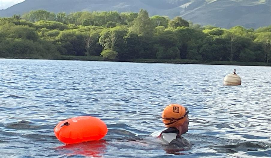 Visitor swimming in Derwentwater with Swim on the Wild Side in Keswick, Lake District